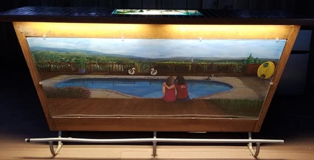 Painting of two friends sitting by a pond